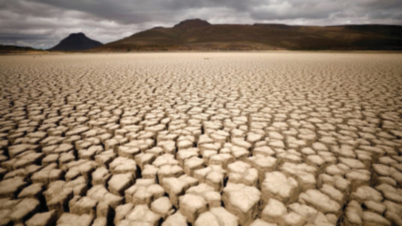FILE PHOTO: Clouds gather but produce no rain as cracks are seen in the dried up municipal dam in ...